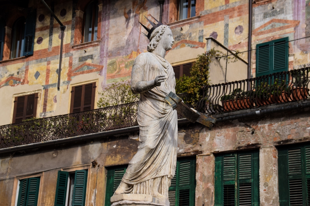 La estatua de Madonna Verona en Piazza delle Erbe. Detrás los frescos de las Case Mazzanti